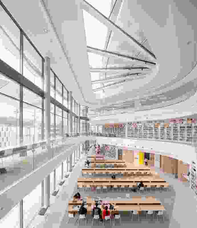 The triple-height atrium of the Reading Room is topped by a large skylight while the glass facade maximizes light and employs operable louvres for shading.