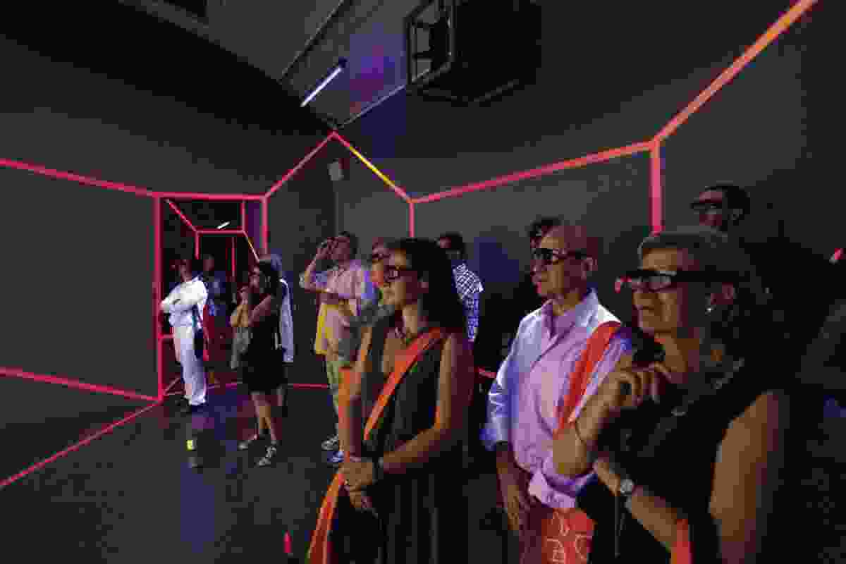 Guests of the pavilion don 3D glasses to view the photography on display.