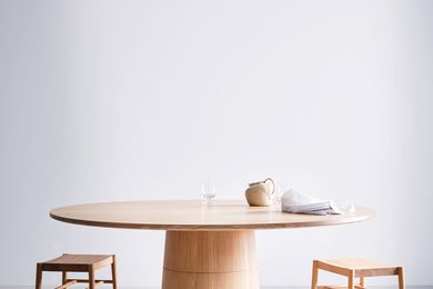 The Rodan dining table is grounded by a solid base that champions the inherent material qualities of timber.
